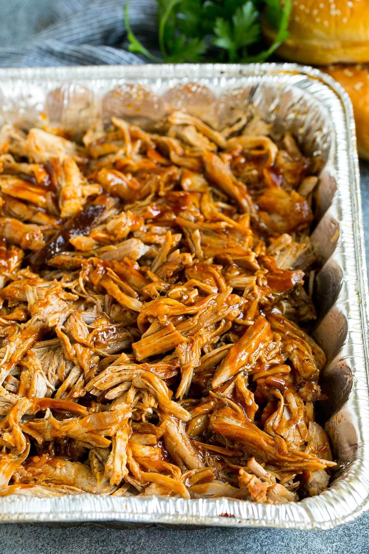 Geräuchertes Pulled Pork 2 Saftiges geräuchertes Pulled Pork in einer Metallschale mit BBQ-Sauce.