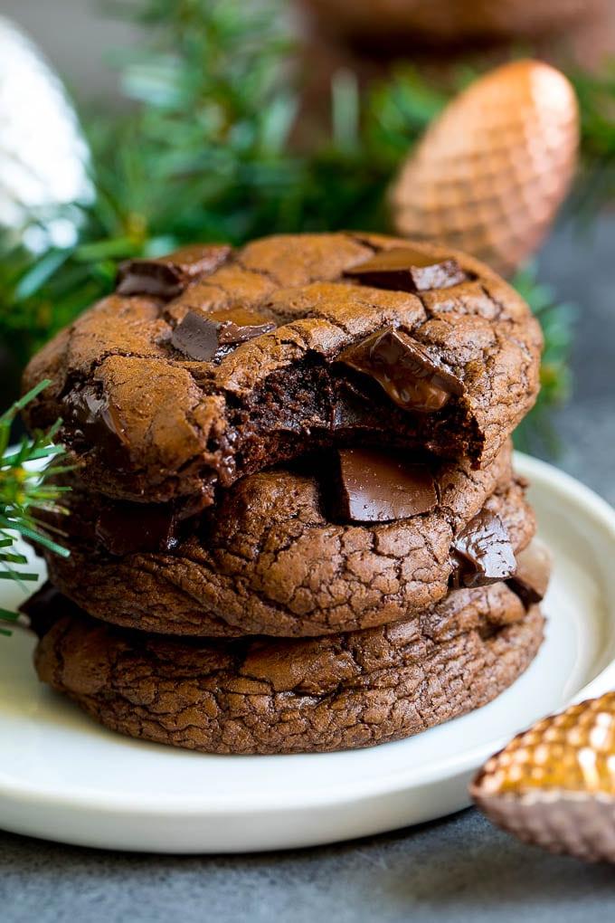 Brownie Cookies Rezept | Schokoladenkekse #kekse #brownies #schokolade #dessert #backen #abendessenimzoo Ein Stapel von frisch gebackenen Brownie Cookies, aus einem wurde ein Bissen genommen.