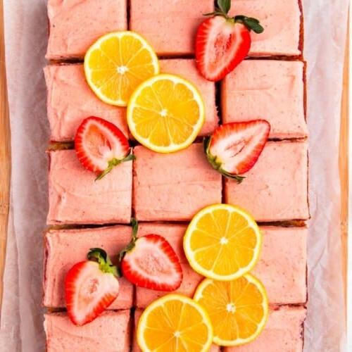 Erdbeer-Zitronen-Kuchen 7 Ein Erdbeer-Zitronen-Kuchen in Quadrate geschnitten und mit frischen Beeren und Zitronenscheiben garniert.