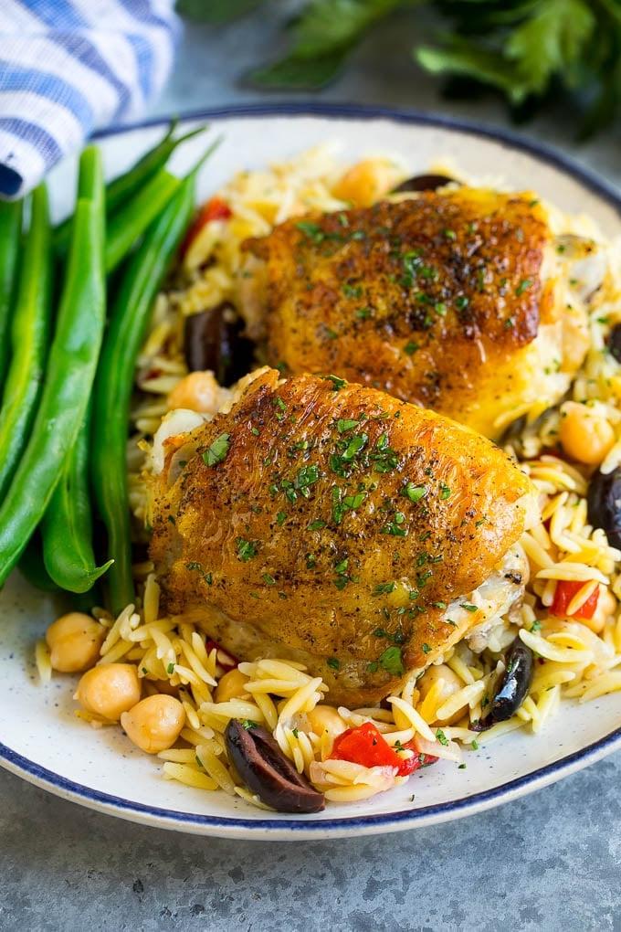 Mediterranean chicken thighs served over orzo with green beans.