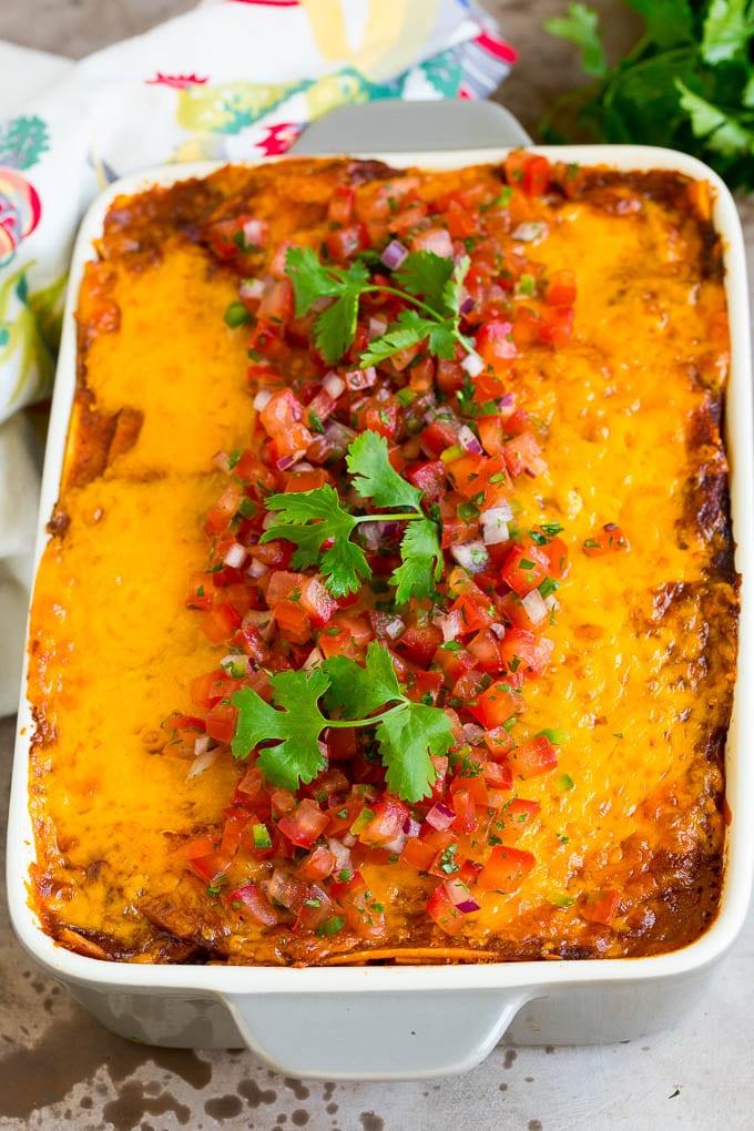Eine Auflaufform mit Taco-Lasagne, garniert mit frischer Salsa und Koriander.