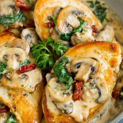 Cremiges Toskanisches Hähnchen 2 Eine Pfanne mit toskanischem Hähnchen, übergossen mit cremiger Pilz- und Spinatsoße.