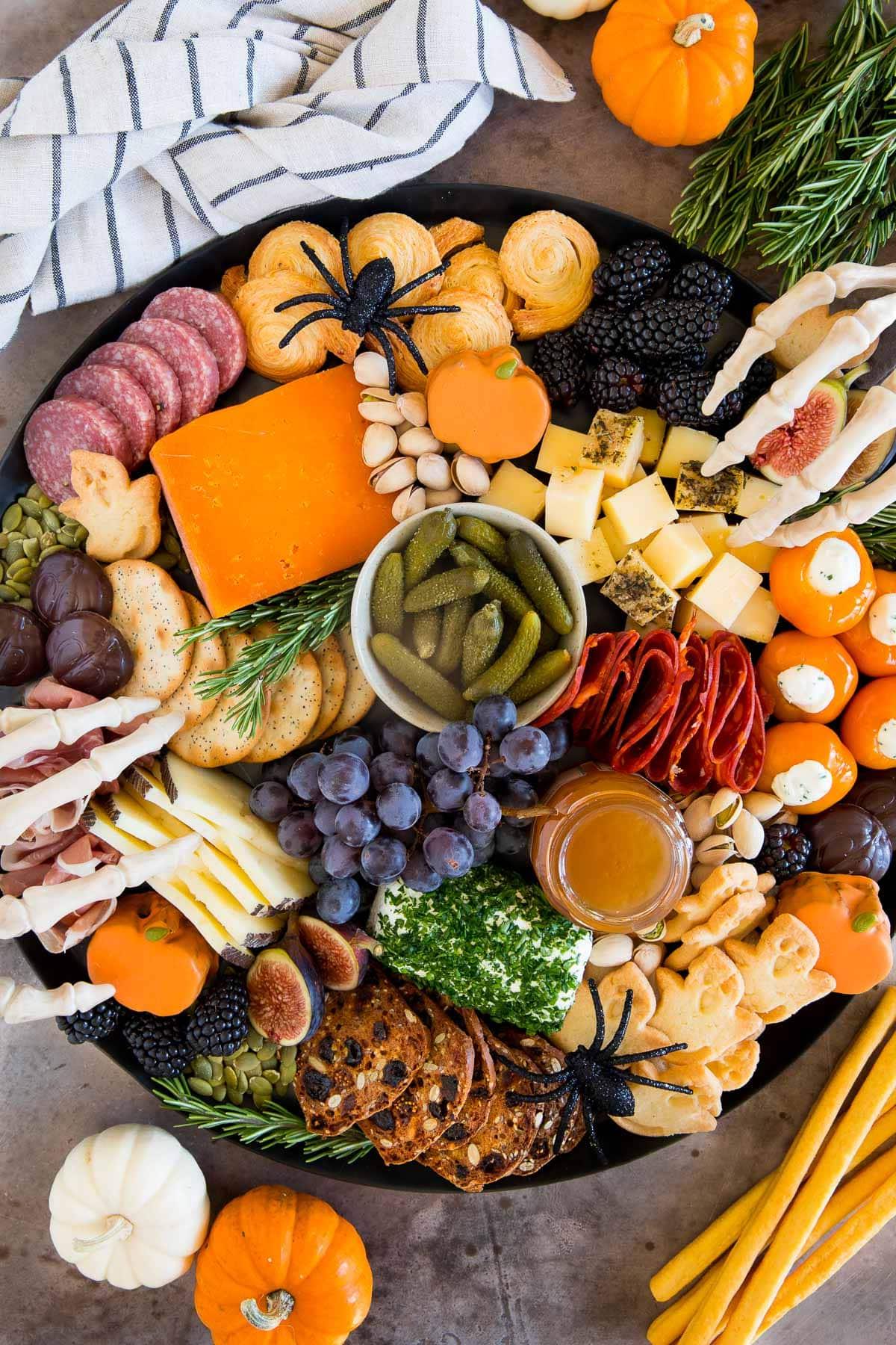Halloween Platte 2 Eine Halloween Charcuterie Board gefüllt mit Wurst, Käse, Crackern und Halloween-Süßigkeiten.