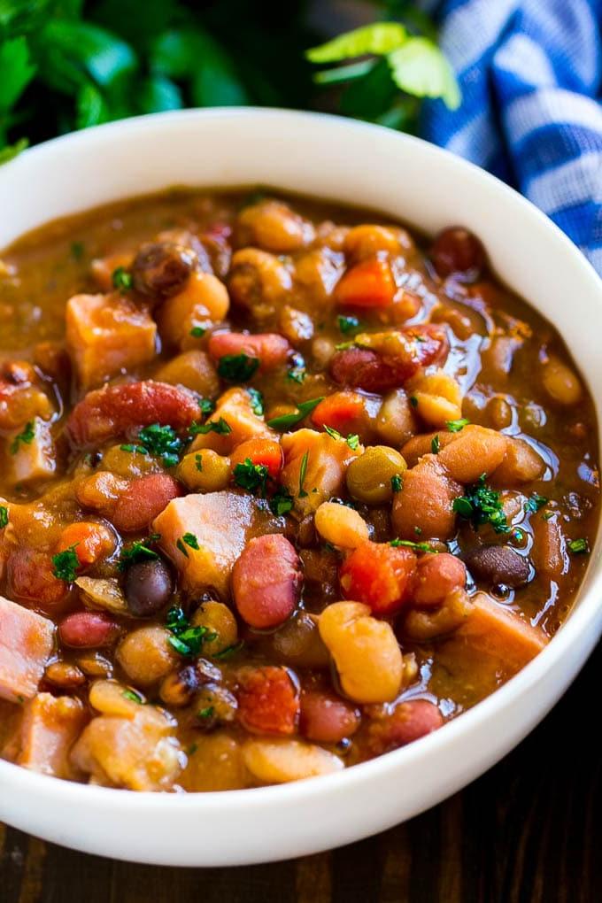 Slow Cooker Schinkenknochensuppe | Schinken-Bohnen-Suppe | Schinkenknochen-Bohnen-Suppe | Schinkensuppe | Rezept für Schinkenreste #schinken #schinkensuppe #schinkenreste #suppe #slowcooker #crockpot #ahurt Eine Schüssel Schinkenknochensuppe mit Bohnen und Gemüse.