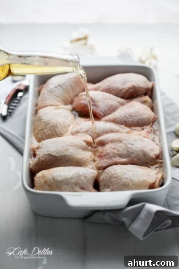 Beer-Crisped Chicken with Mushroom Ale Gravy 4 Beer being dripped over raw chicken pieces