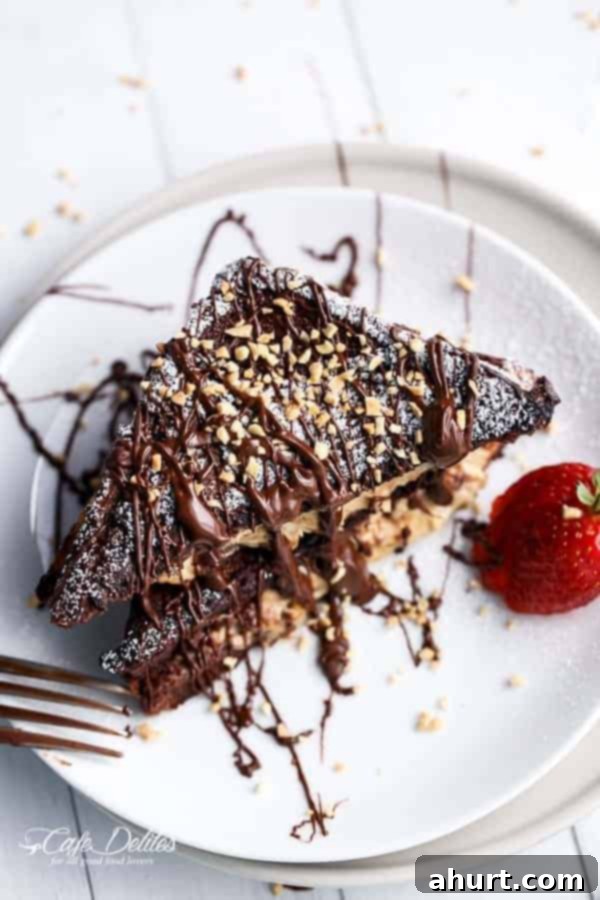 A piece of Peanut Butter Cheesecake Stuffed Chocolate Brownie French Toasts on a plate