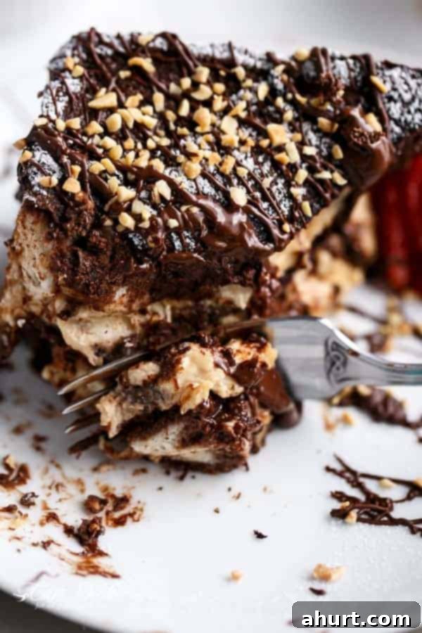 A bite cute with fork from Peanut Butter Cheesecake Stuffed Chocolate Brownie French Toasts 