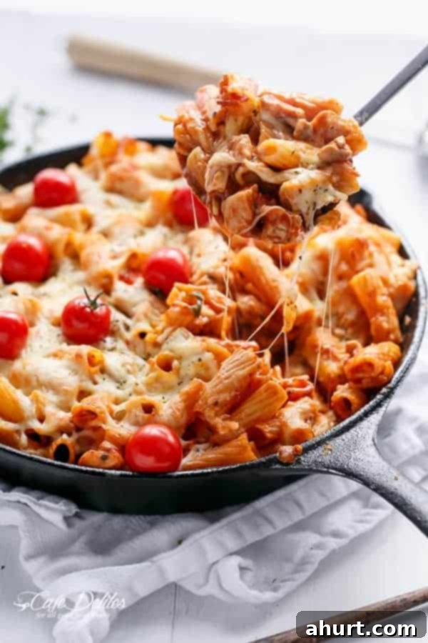 Delicious Cheesy Chicken and Roasted Tomato Mozzarella Pasta Bake in a pan