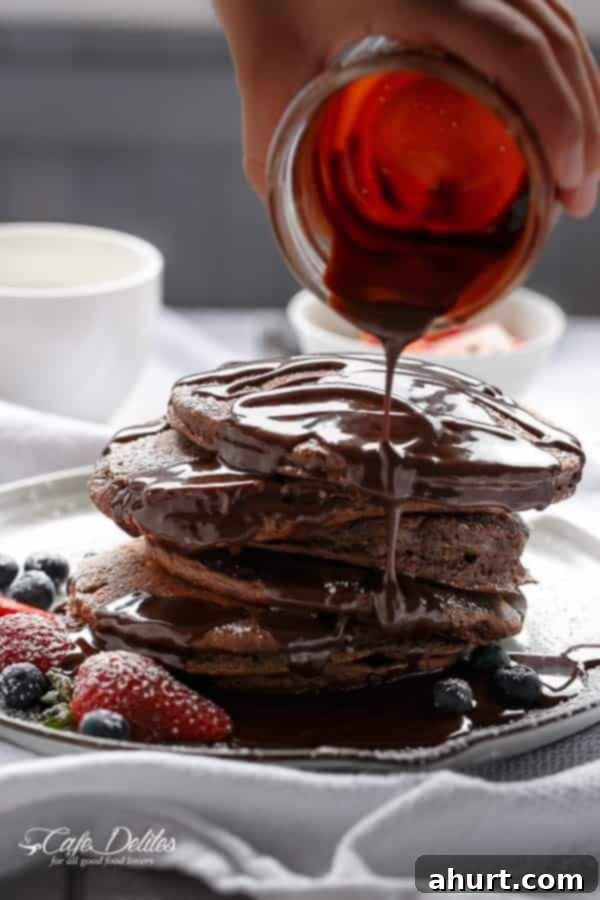 Double Chocolate Brownie Pancakes fully drenched into chocolate sauce