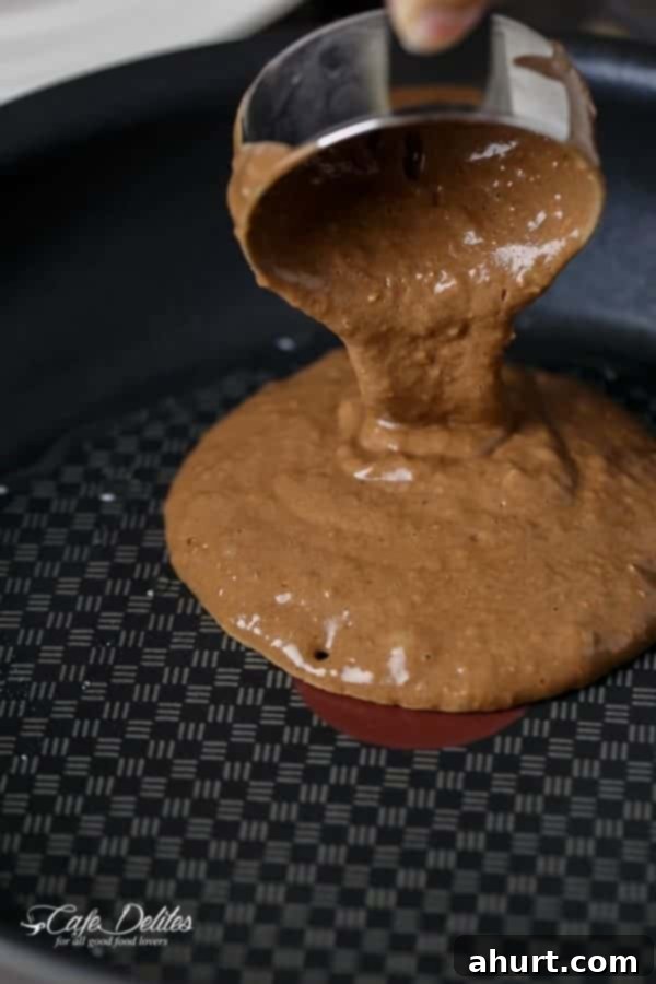 Double Chocolate Brownie Pancakes mixture being poured over the baking tray