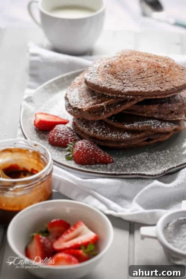 Double Chocolate Brownie Pancakes on a plate with fresh berries kept aside for decoration