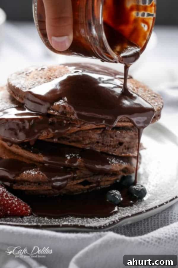 Chocolate sauce dripped over Double Chocolate Brownie Pancakes