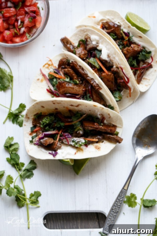 Delicious Korean Bulgogi BBQ Beef Tacos served with a spoon on a rustic wooden tray