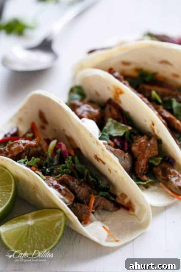Close-up overhead view of a single Korean Bulgogi BBQ Beef Taco, showcasing its flavorful fillings