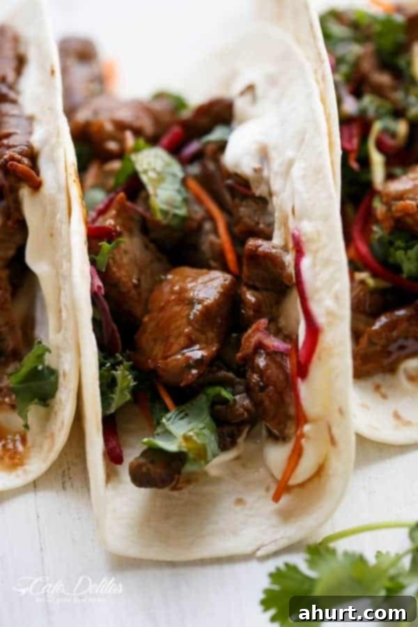Detailed close-up of a perfectly constructed Korean Bulgogi BBQ Beef Taco, ready to eat