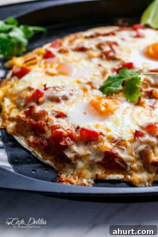 Huevos Rancheros Tortilla Pizza 5 Cooked Huevos Rancheros Tortizza (Tortilla Pizza) on a plate, showcasing the perfectly baked eggs and melted cheese