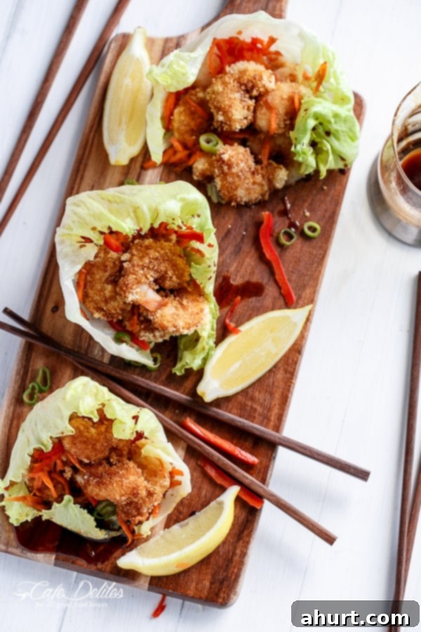 Crispy Oven-Fried Tempura Shrimp Lettuce Wraps with Teriyaki Sauce 3 Oven Fried Tempura Batter Shrimp Lettuce Wraps with Teriyaki Sauce on a wooden tray