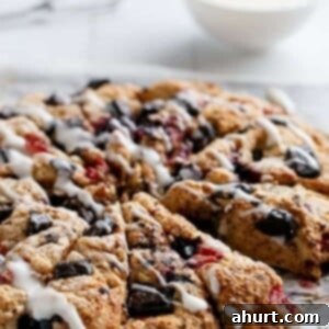 Luscious Berry Chocolate Buttermilk Scones with Cream Cheese Glaze 11 Mixed Berry and Chocolate Chunk Buttermilk Scones with a Cream Cheese Glaze on a tray