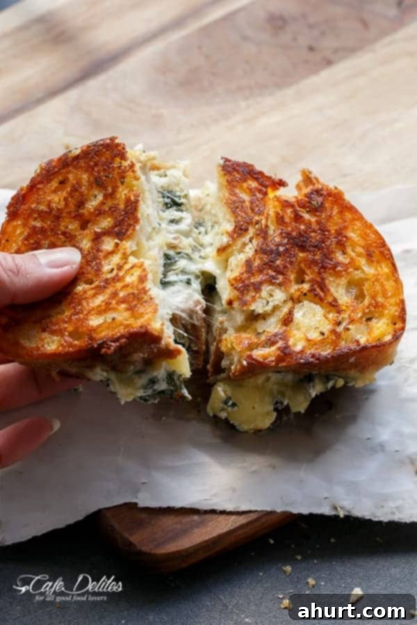 Creamy Spinach and Ricotta Grilled Cheese 3 Spinach and Ricotta Grilled Cheese sandwich cut into halves, showing the creamy filling