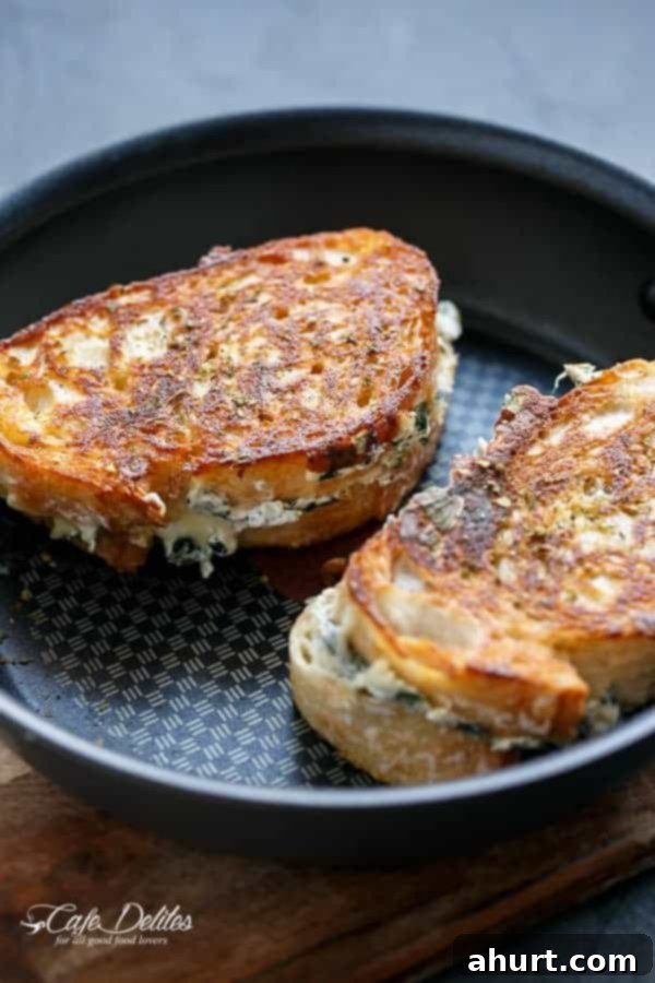 Creamy Spinach and Ricotta Grilled Cheese 5 Spinach and Ricotta Grilled Cheese sandwich cooking on a skillet