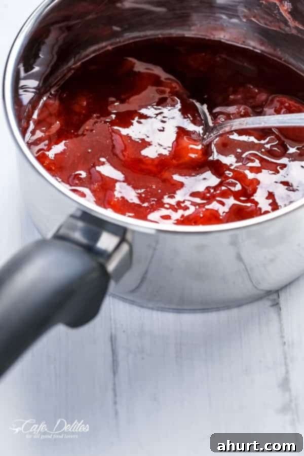 Close-up of strawberry sauce being made in a saucepan