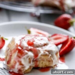 Quick No-Yeast Strawberry Cream Cinnamon Rolls 10 No Yeast Strawberries And Cream Cinnamon Rolls on a plate