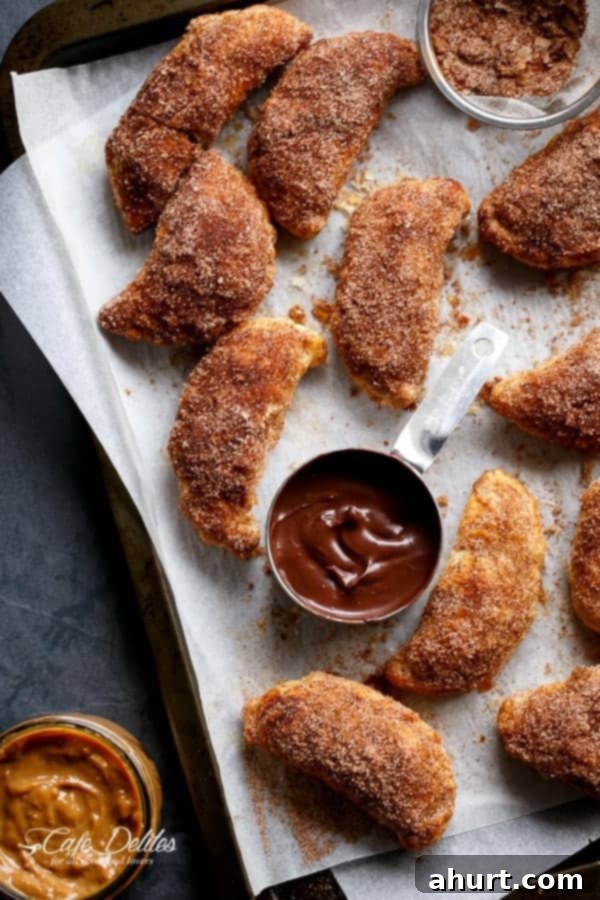 Golden Churro Caramel Hand Pies 2 Dulce De Leche Churro Empanadas pieces on a baking tray