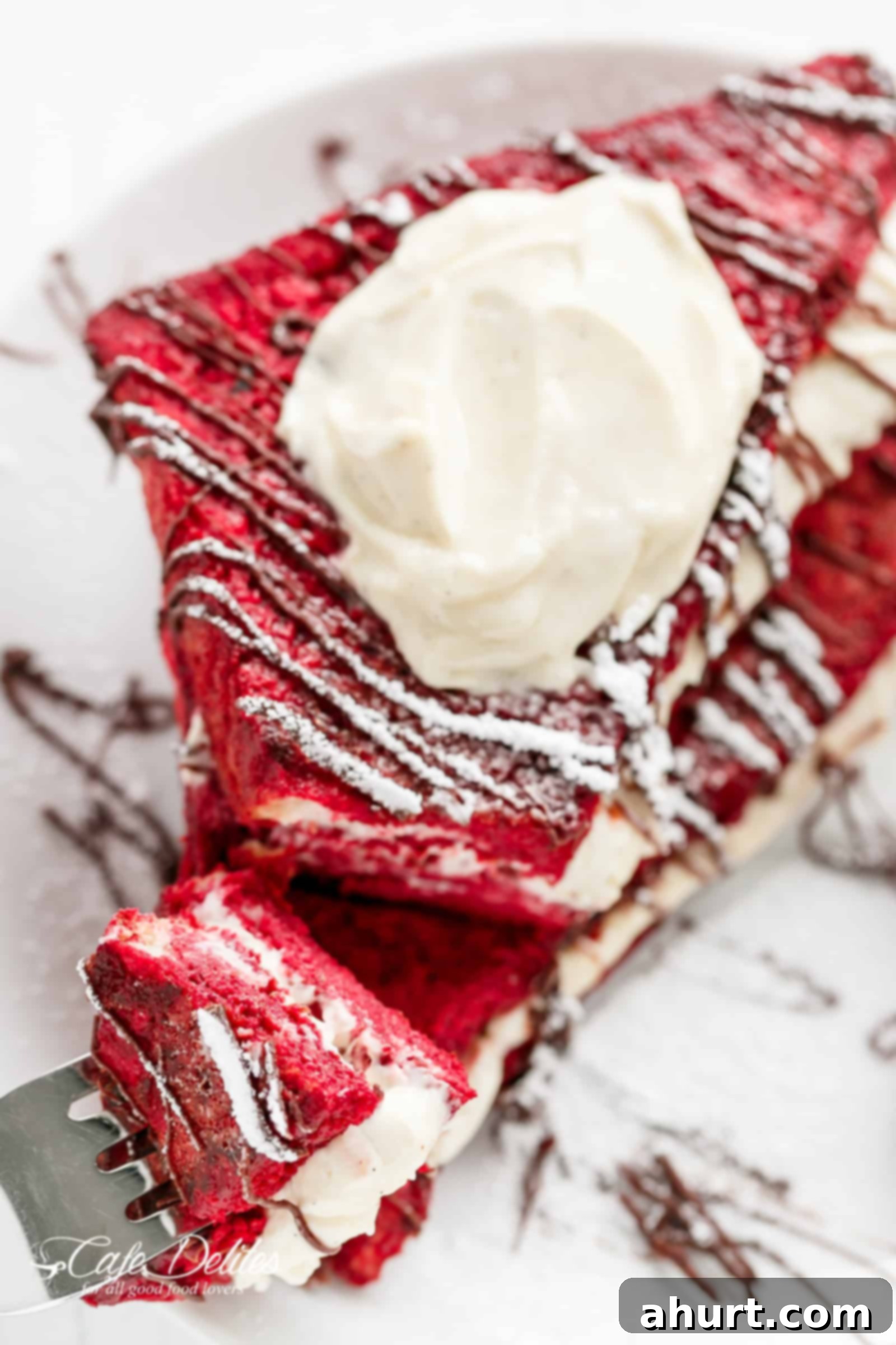 Red Velvet French Toast with a dollop of creamy topping and powdered sugar, ready for serving