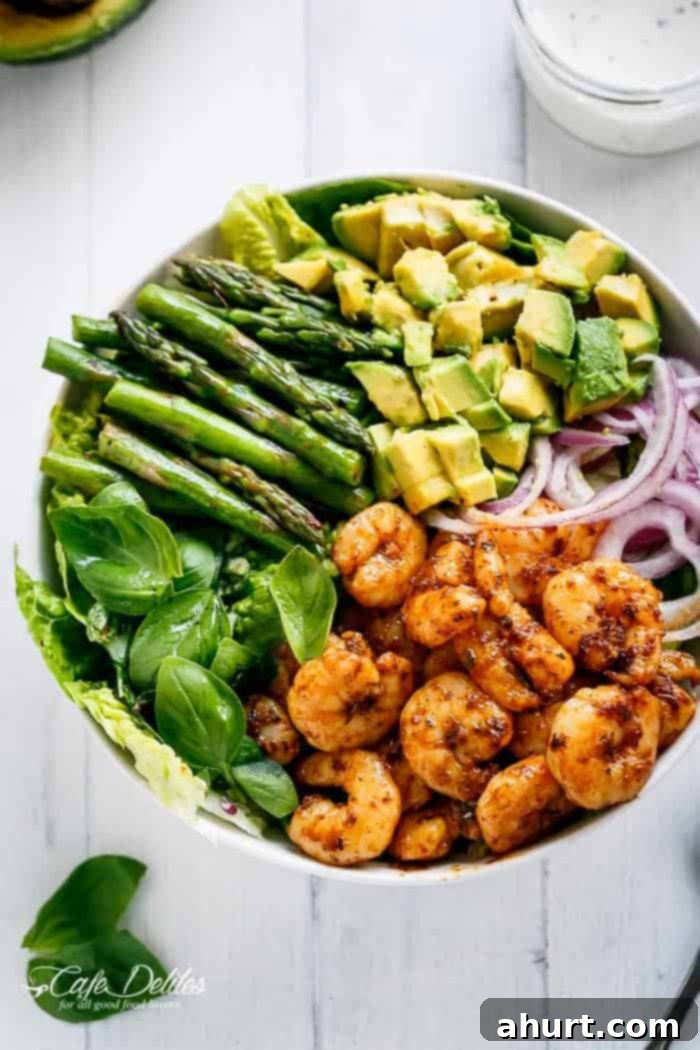 Seared Blackened Shrimp & Vibrant Green Salad 2 A vibrant bowl of Blackened Shrimp, Asparagus and Avocado Salad with Lemon Pepper Yogurt Dressing, showcasing the rich colors of shrimp, green asparagus, and creamy avocado.