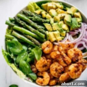 Seared Blackened Shrimp & Vibrant Green Salad 6 Blackened Shrimp, Asparagus and Avocado Salad with Lemon Pepper Yogurt Dressing in a bowl