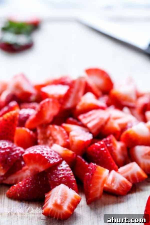 Close-up of fresh, ripe strawberry pieces, ready to be transformed into syrup.