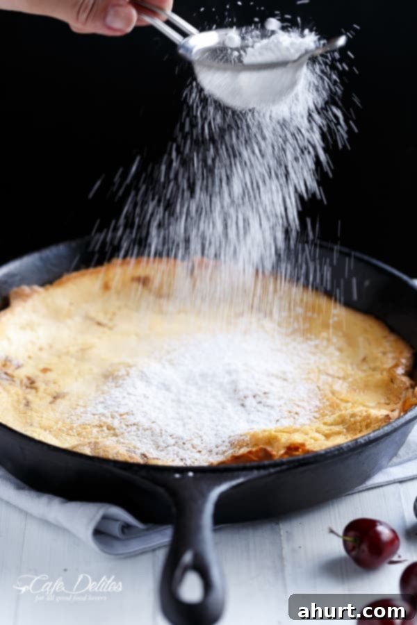 Toasted Butter Chocolate-Cherry Sky-High Pancake 3 Sugar sprinkling over Chocolate-Cherry Browned Butter German Pancake