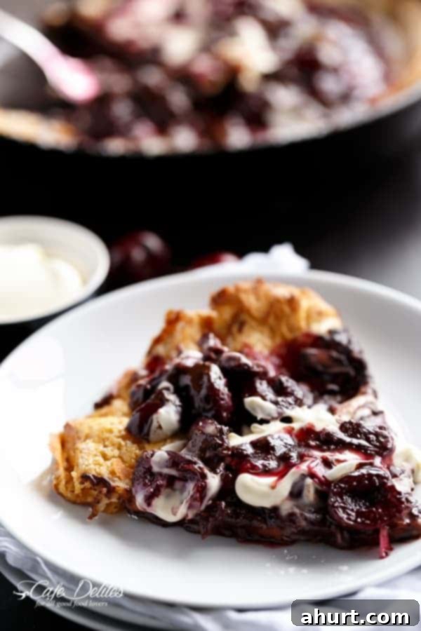 Toasted Butter Chocolate-Cherry Sky-High Pancake 8 Chocolate-Cherry German Pancake (or Dutch Baby Pancake) piece on a plate