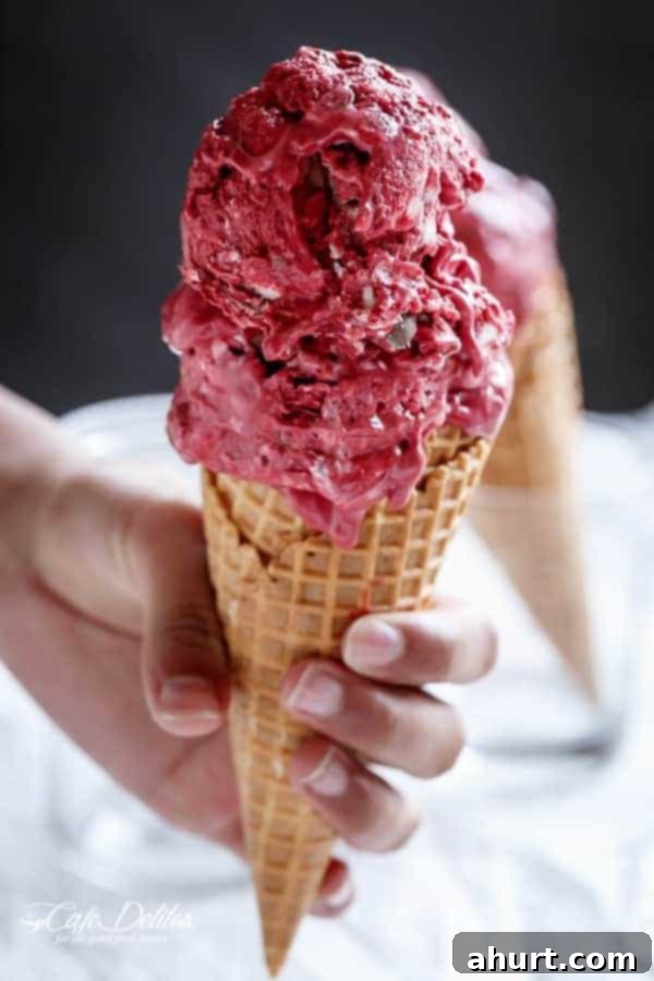 Decadent Red Velvet Cookie Dough Frozen Yogurt 4 A serving of Red Velvet Cookie Dough Frozen Yogurt with a Vanilla Bean Cream Cheese Swirl on a classic waffle cone.