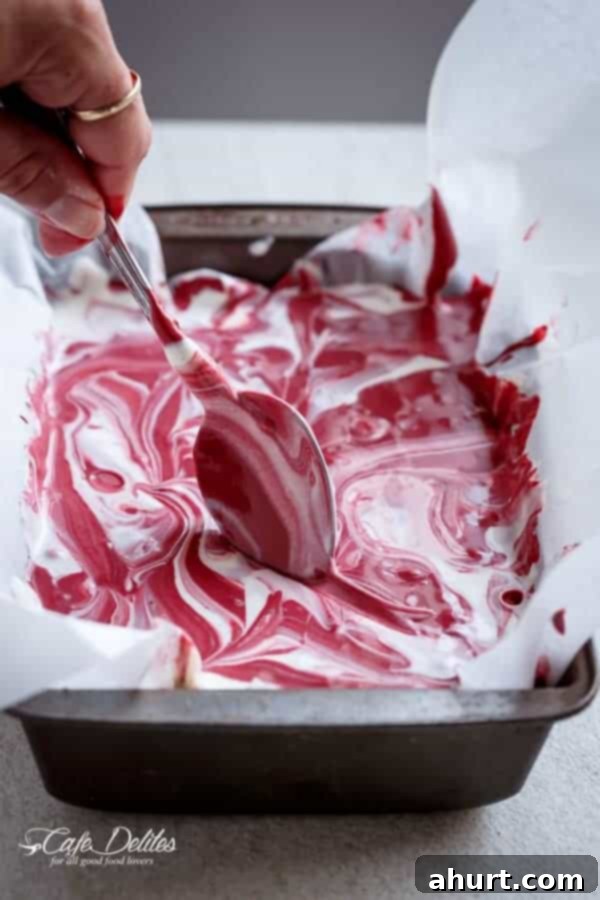 Decadent Red Velvet Cookie Dough Frozen Yogurt 6 Spreading of Red Velvet Cookie Dough Frozen Yogurt mixture onto a baking tray before freezing.
