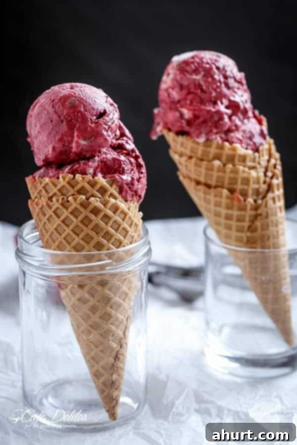 Decadent Red Velvet Cookie Dough Frozen Yogurt 8 Scoops of Red Velvet Cookie Dough Frozen Yogurt with a Vanilla Bean Cream Cheese Swirl in a bowl, showcasing its readiness for enjoyment.