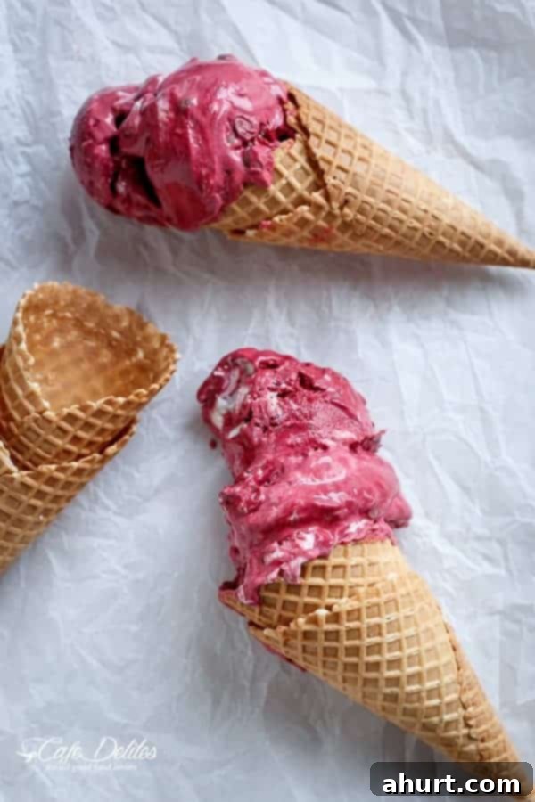 Decadent Red Velvet Cookie Dough Frozen Yogurt 9 Red Velvet Cookie Dough Frozen Yogurt with a Vanilla Bean Cream Cheese Swirl in a jar, with a waffle cone beside it.
