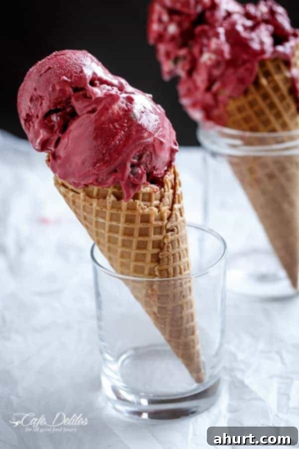 Decadent Red Velvet Cookie Dough Frozen Yogurt 10 Red Velvet Cookie Dough Frozen Yogurt with a Vanilla Bean Cream Cheese Swirl in a glass jar, with a waffle cone peeking out.