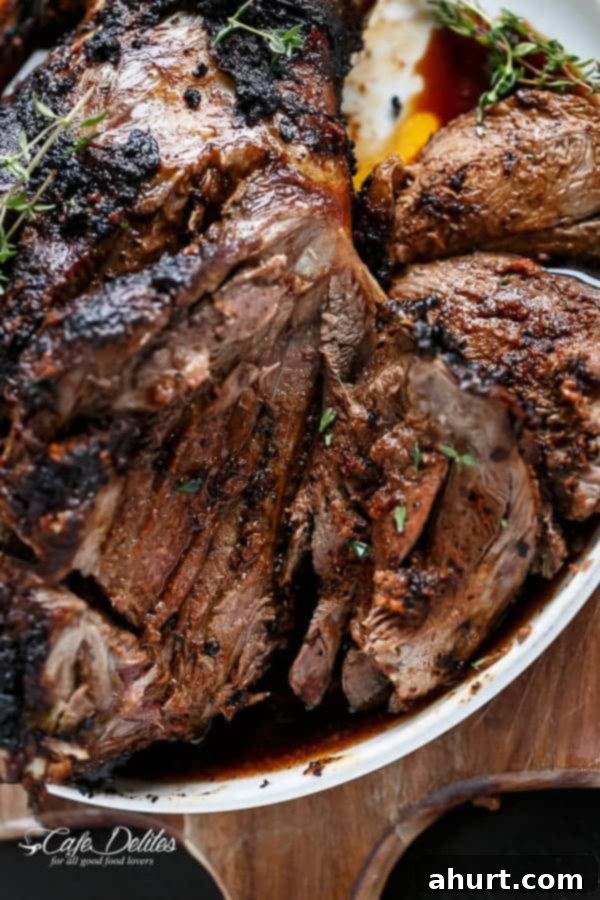 Close-up of perfectly sliced Sundried Tomato and Garlic Roast Lamb with juices