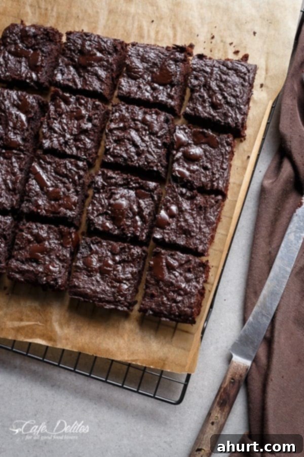 Fudgy Keto Zucchini Brownies 6 Freshly baked Low Carb Zucchini Brownies cut into squares, showcasing their dense and fudgy interior.