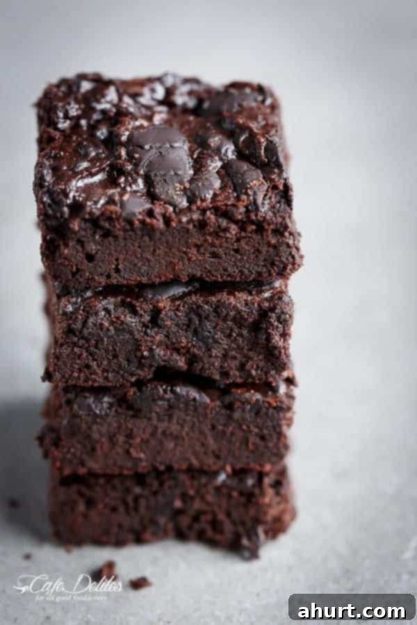 Fudgy Keto Zucchini Brownies 7 Stack of three Low Carb Zucchini Brownies, emphasizing their thick, decadent appearance.