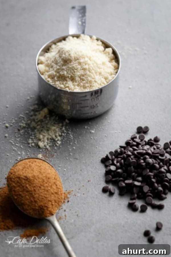 A flat lay of ingredients laid out for making the Low Carb Browned Butter Chocolate Chip Skillet Cookie, including almond flour, chocolate chips, and sweeteners.