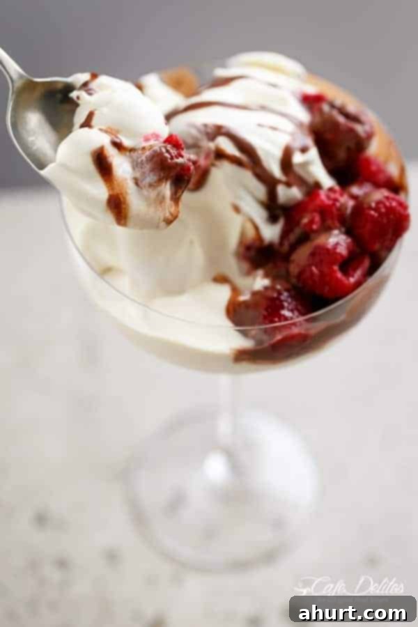 Decadent Kahlua Raspberry Cheesecake Parfaits 7 Zoomed-in image of Creamy Kahlua Raspberry Cheesecake Parfaits, focusing on the creamy texture and fruit.