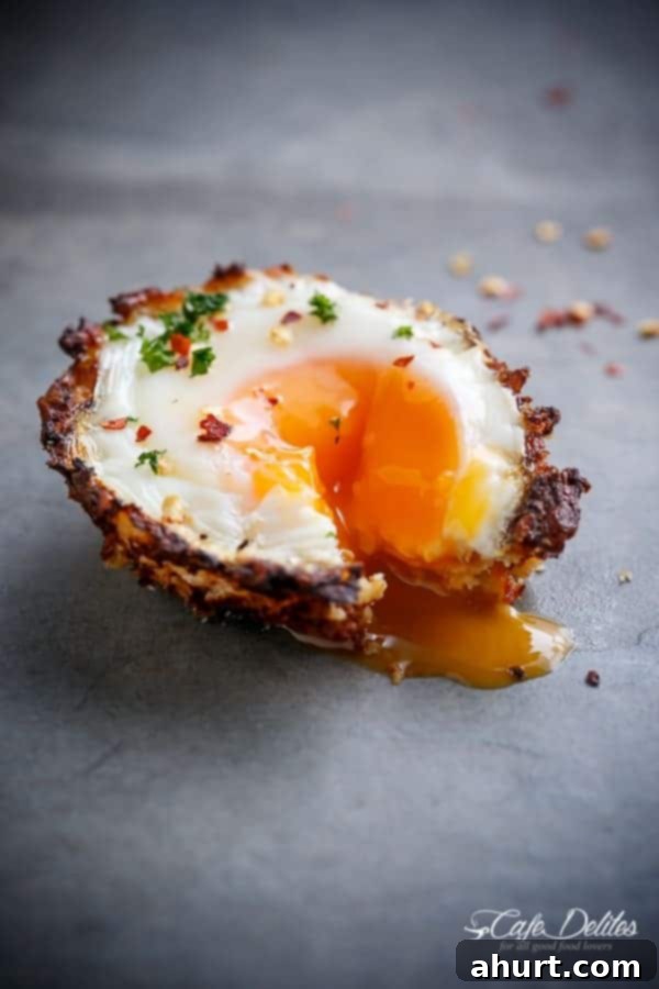 Cauliflower Hash Brown Egg Cups with a perfectly runny egg. A single image of Cauliflower Hash Brown Egg Cups (Low Carb + Gluten Free)