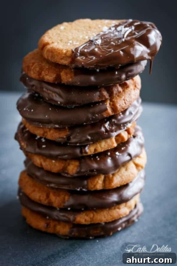 Stack of Salted Chocolate Dipped Peanut Butter Cookies, showcasing their chewy texture and chocolate coating