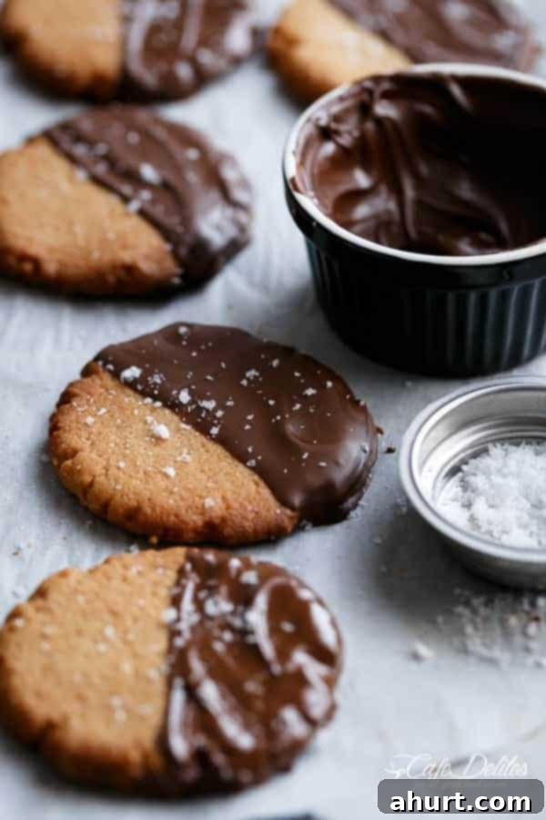 Close-up of a Salted Chocolate Dipped Peanut Butter Cookie with a bite taken out, showing the soft interior