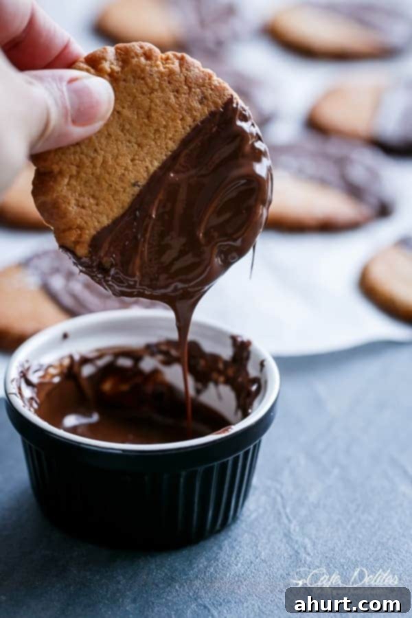 Close-up of a freshly baked Salted Chocolate Dipped Peanut Butter Cookie with melted chocolate