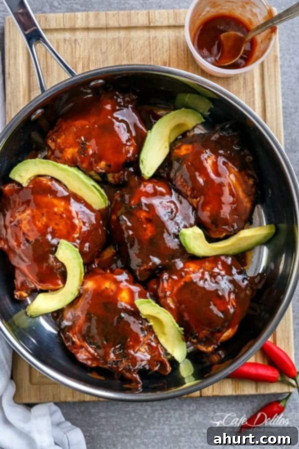 Tangy Barbecue Buffalo Chicken Thighs with Creamy Avocado 2 Top view image of Crispy Barbecue Buffalo Chicken Thighs with Avocado in a pan, showcasing the golden-brown chicken and vibrant green avocado slices.