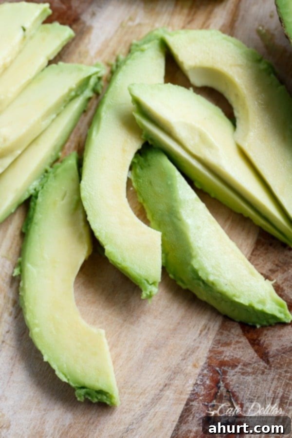 Tangy Barbecue Buffalo Chicken Thighs with Creamy Avocado 3 Close-up image of perfectly sliced ripe avocado, ready to complement a spicy dish.