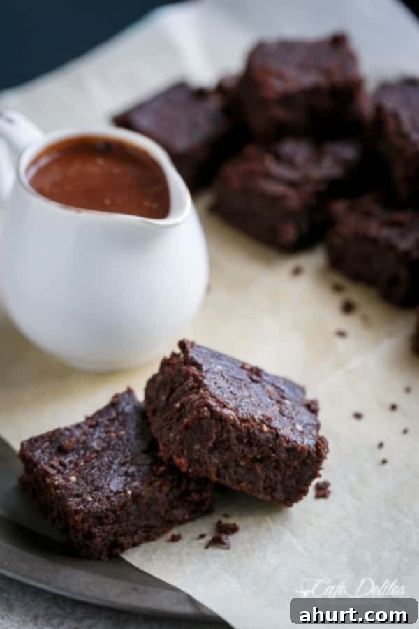 Decadent Low Carb Flourless Hazelnut Brownies 7 Close-up of a Fudgy Flourless Hazelnut Brownie with hot fudge sauce and ice cream